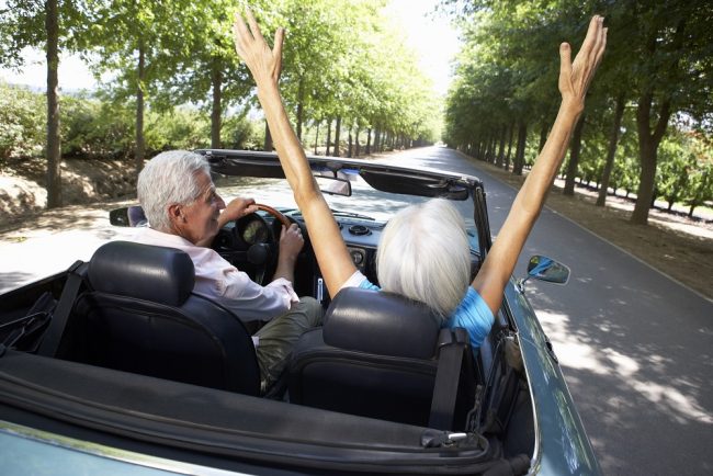 Senior couple in sports car